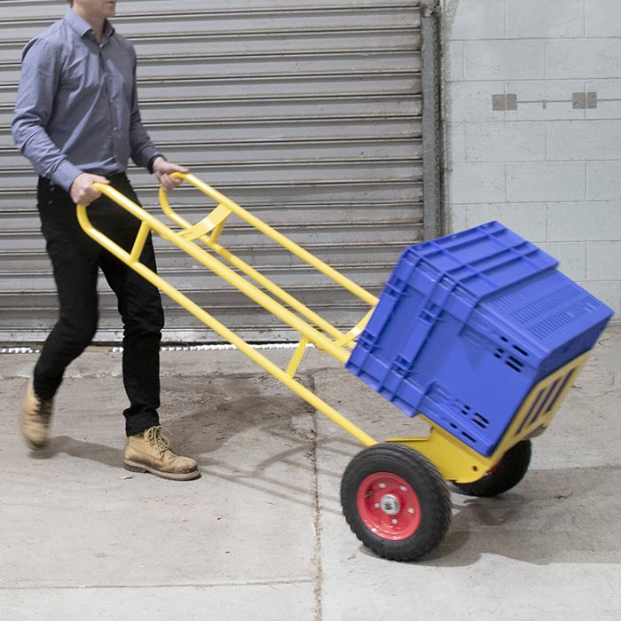 Hand truck with pneumatic wheels carrying boxes in a warehouse